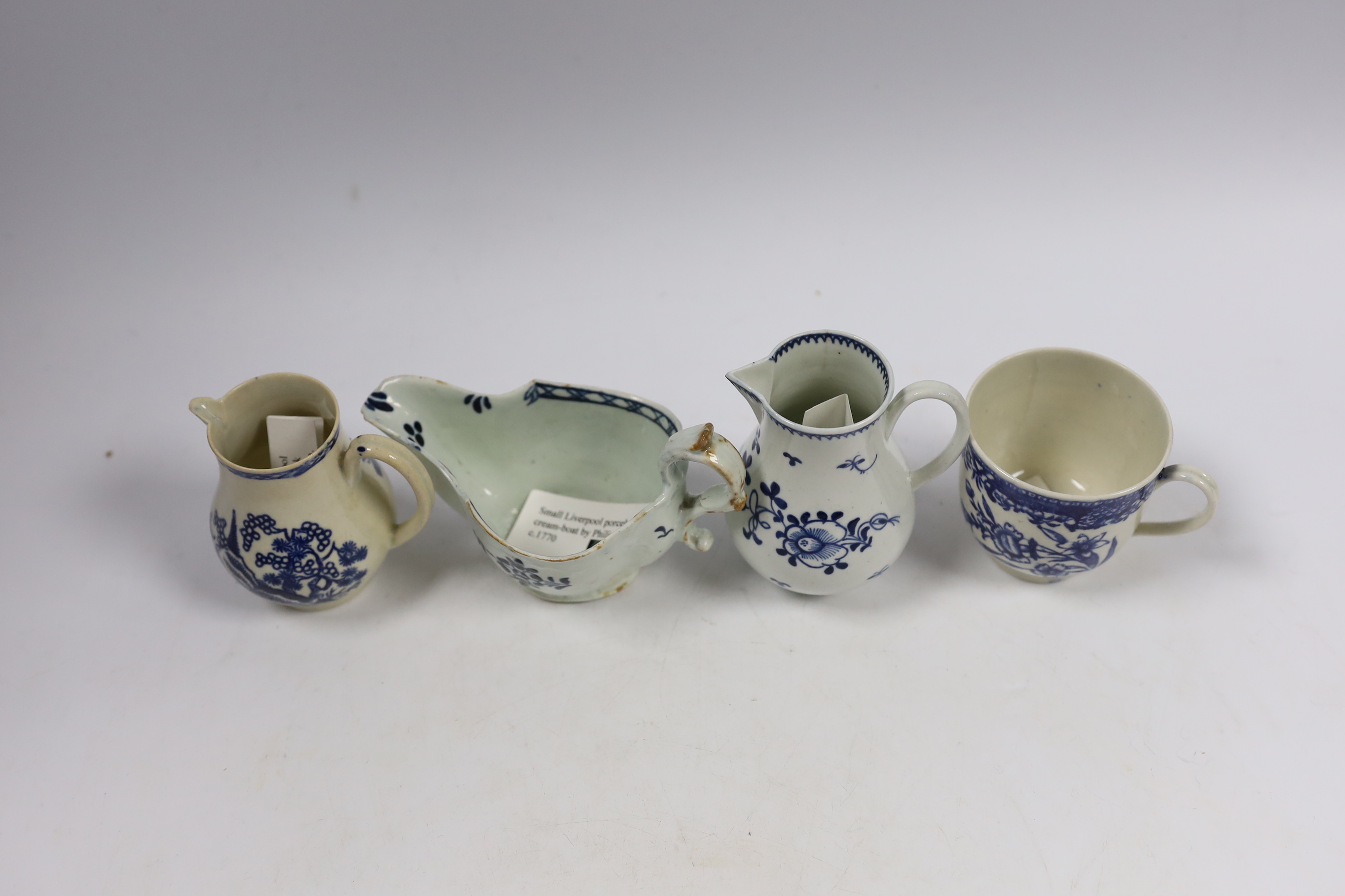 Christian or Pennington, Liverpool porcelain - a sauceboat, two milk jugs and a coffee cup, largest 13cm wide